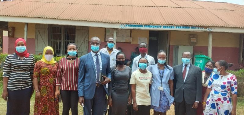 Dr Mutungi (4th from left) and Dr Musinguzi (3rd from right) with health care workers at Kasangati Health Centre. 