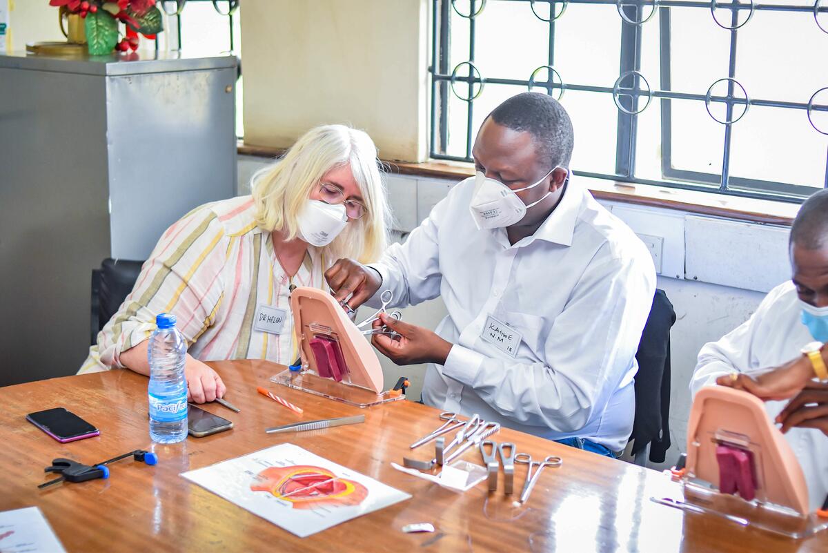 Dr. Helen Allott, course director, supports a UoN resident as he practices skills to repair of obstetric anal sphincter injury