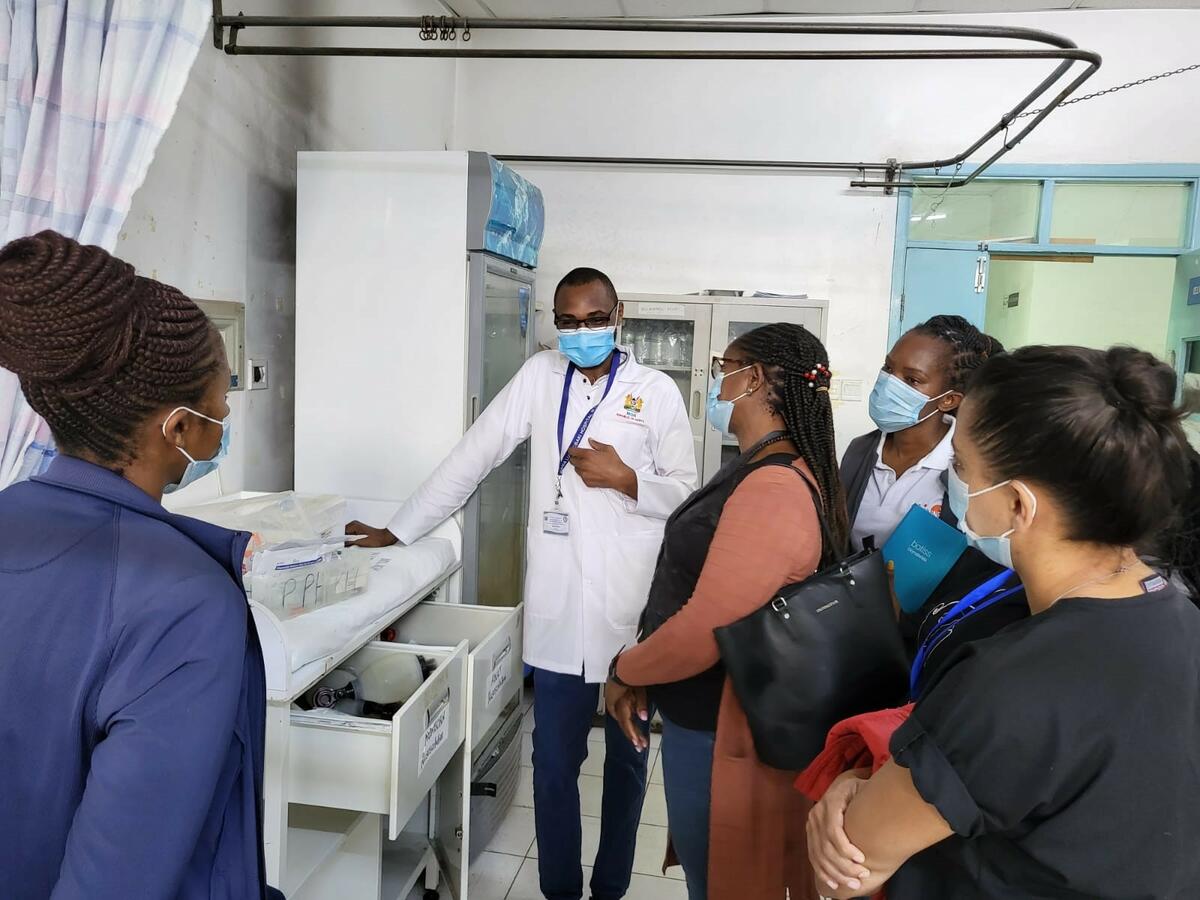 Health worker (centre) at Mama Lucy Hospital and maternity in-charge (left) talk to the visiting County health team. /credit LSTM