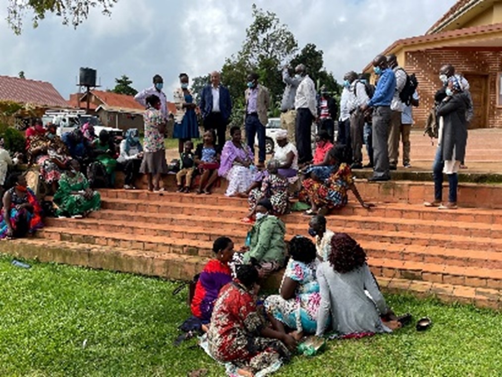 Research team consulting with patients living with HIV and receiving community care (at a church) in Uganda