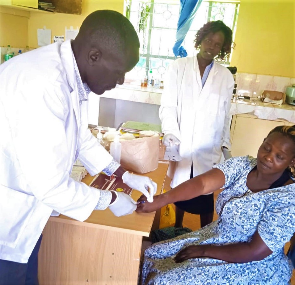 Nurse Ben draws a blood sample from a pregnant mother in the first trimester to be screened for anaemia