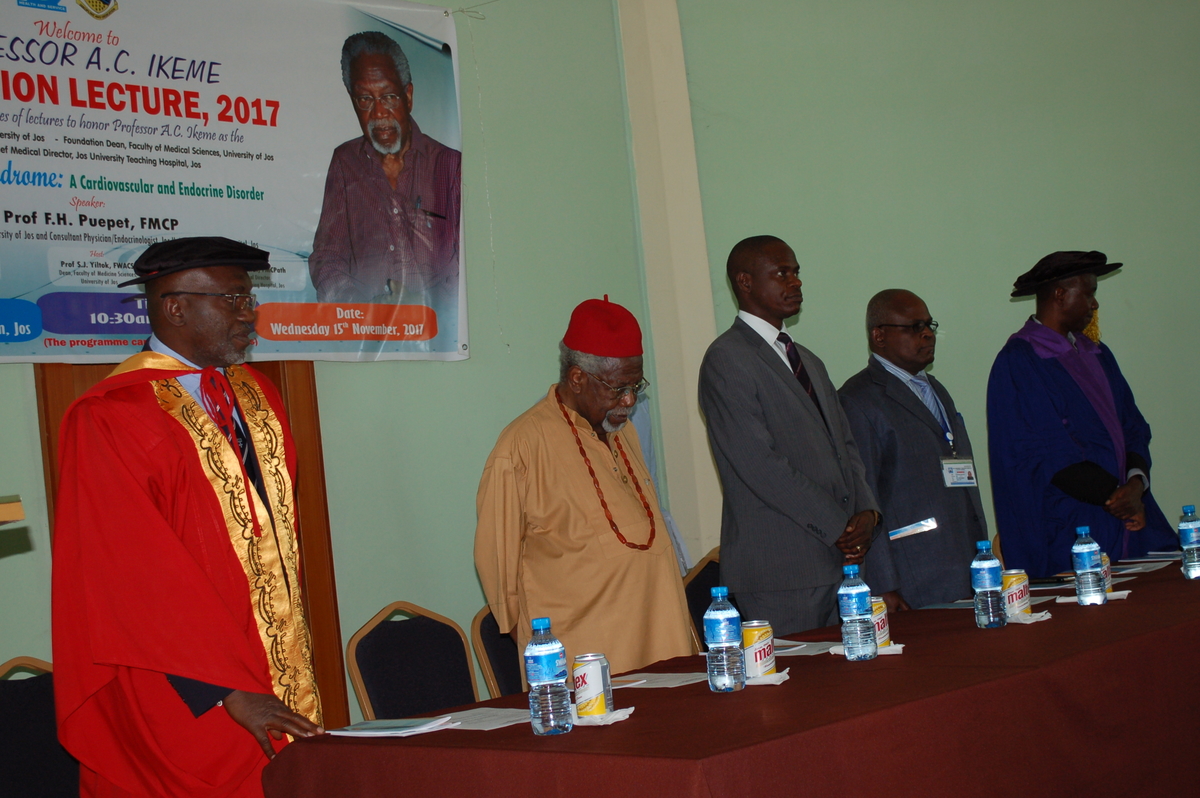 Prof Ikeme in red hat and guest lecturer, Prof Puepet Fabian in red academic gown Prof Ikeme in red hat and guest lecturer, Prof Puepet Fabian, in red academic gown