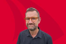 Portrait photo of Julian Eaton on a red background