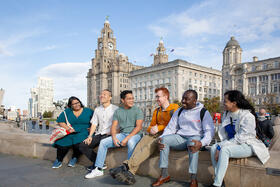 Photo of a group of LSTM students infront of the Liver Building in Liverpool