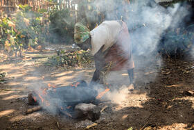 Ari tribe woman cooking injera on the open fire. Jinka, Omo River Valley, Ethiopia.