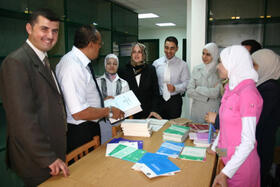 The graduates talking to Dr. Hassan