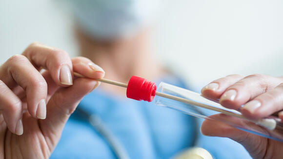 Close up of doctor with saliva sample from sick woman