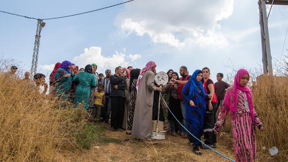 Refugees waiting to receive aid packages from humanitarian aid organisations in the Beqaa region Lebanon.