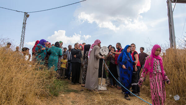 Refugees waiting to receive aid packages from humanitarian aid organisations in the Beqaa region Lebanon.