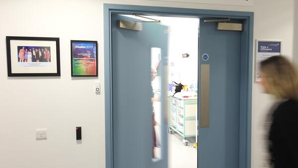 The entrance of the accelerator research clinic. A nurse welcomes a patient