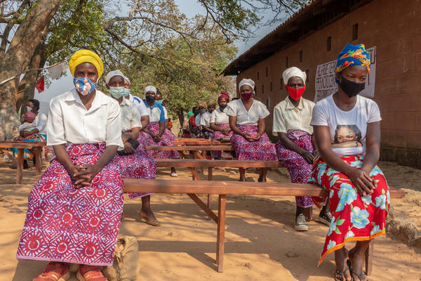 Women dressed in African fabrics and socially distanced