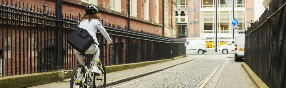 woman cycling through the city centre