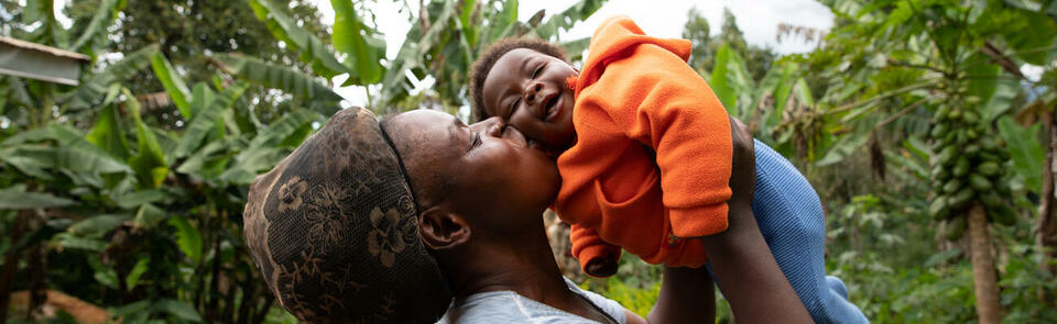 African mother kisses her newborn daughter