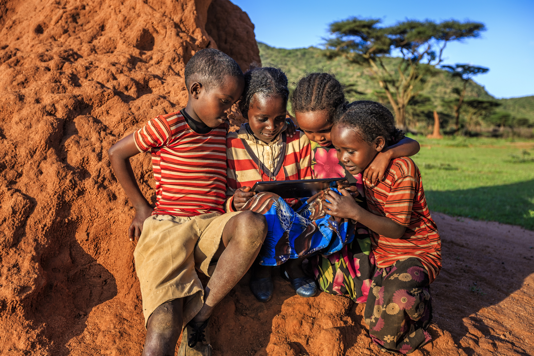 Little African children using digital tablet in the village in Southern Ethiopia, Africa. /Credit:hadynyah