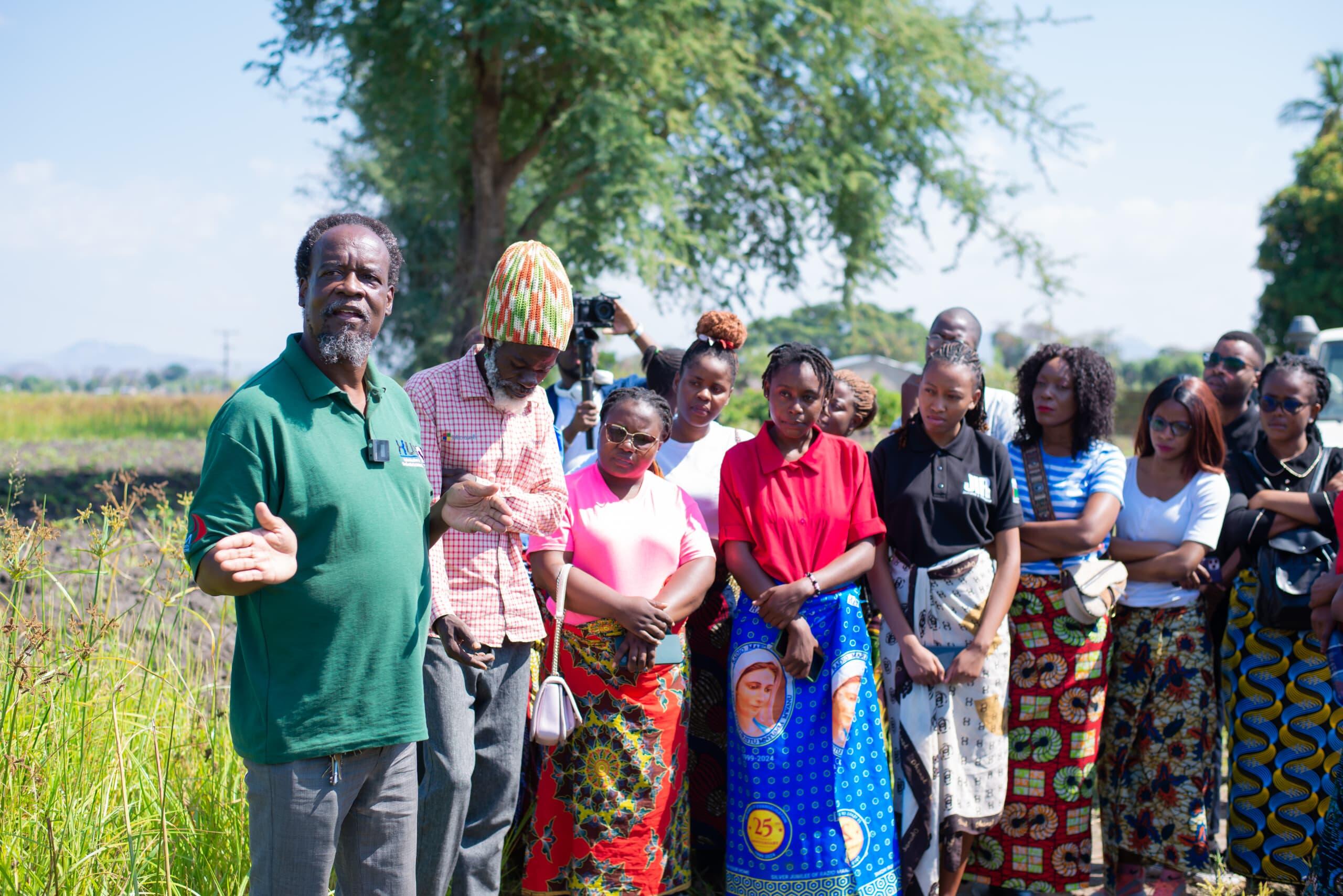 Peter Makaula (in green shirt) leading a community discussion group around Samama village