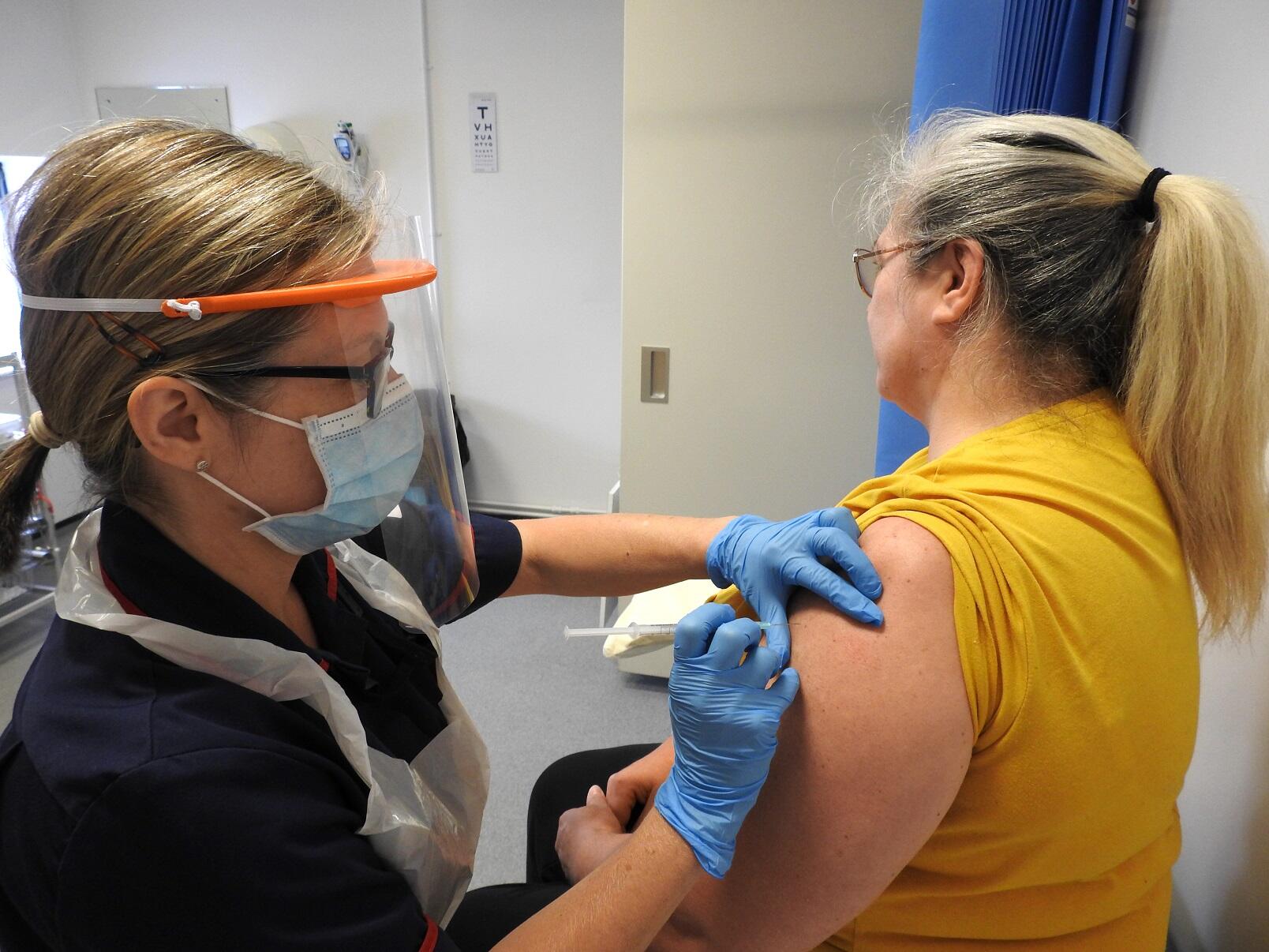 WTC staff member vaccinates a volunteer as part of the Oxford COVID-19 vaccine trial