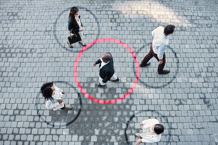 Shot of a group of people wearing masks in the city with circles around them indicating Covid-19 tracing and transmission