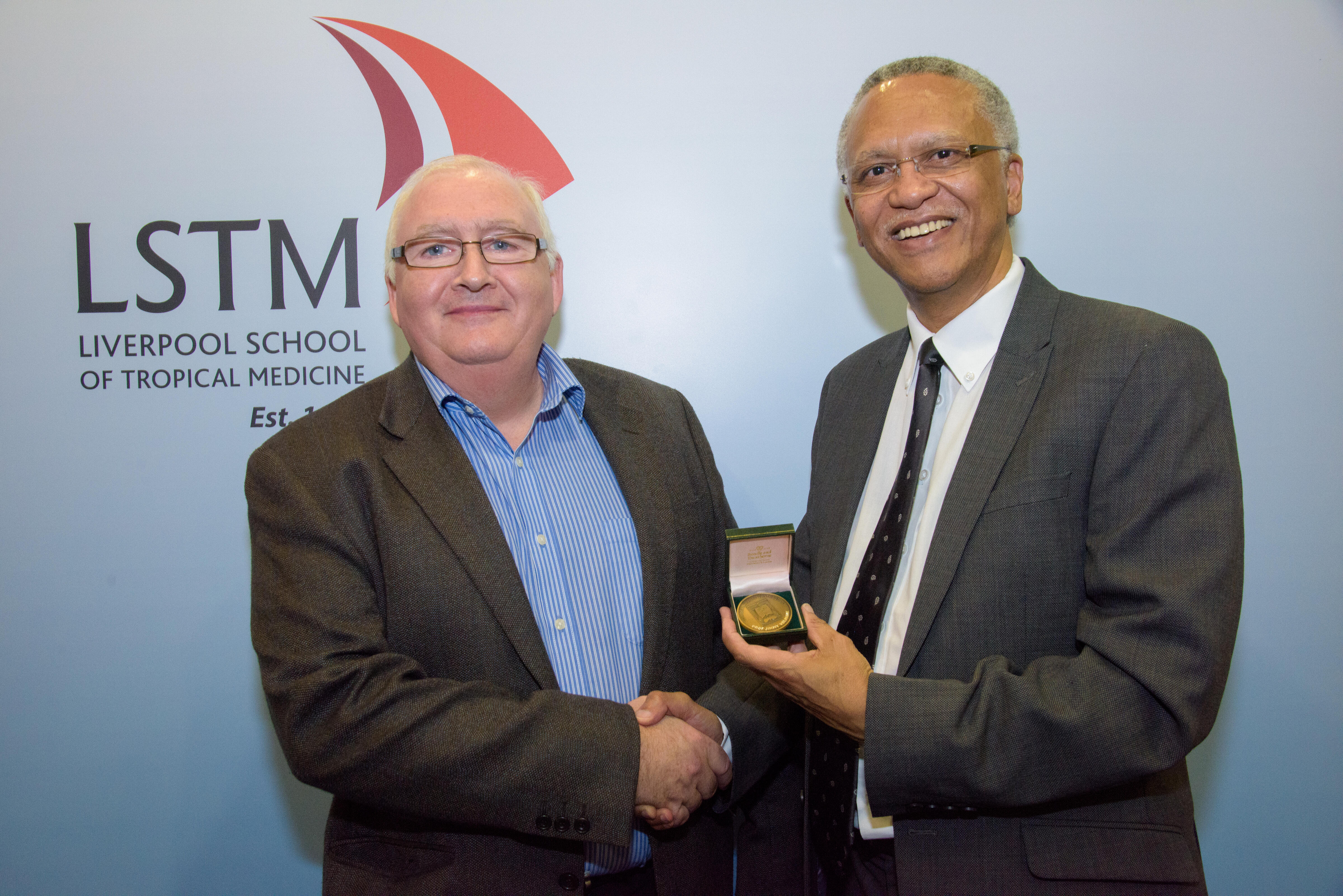 Professor Steve Ward (left) presents the Leverhulme Medal to Professor Jimmy Volmink