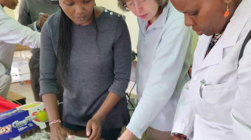 Wanjiku and Ingeborg using available resources to demonstrate the use of Ultrasound in vascular access and biopsy training (chicken breasts with olives hidden inside!)