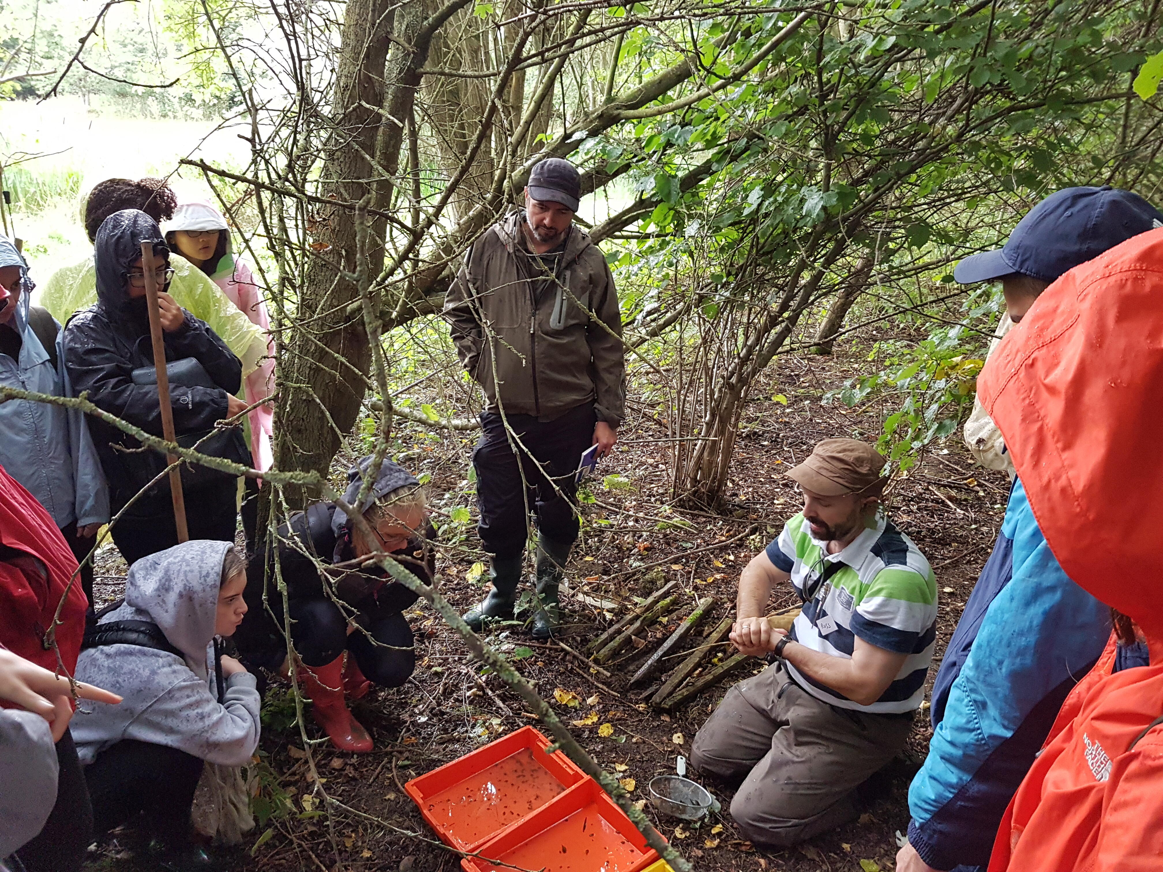 Professor Stothard (seated) teaching fresh water sampling to MSc students 