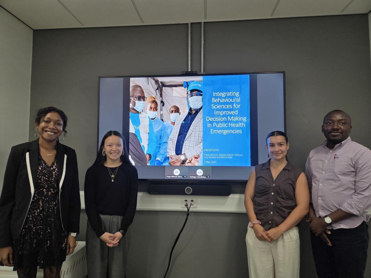 UNICEF said that the students’ initial insights will be the foundation for a broader set of research activities The group of 4 LSTM students stand in front of a TV screen presenting their work