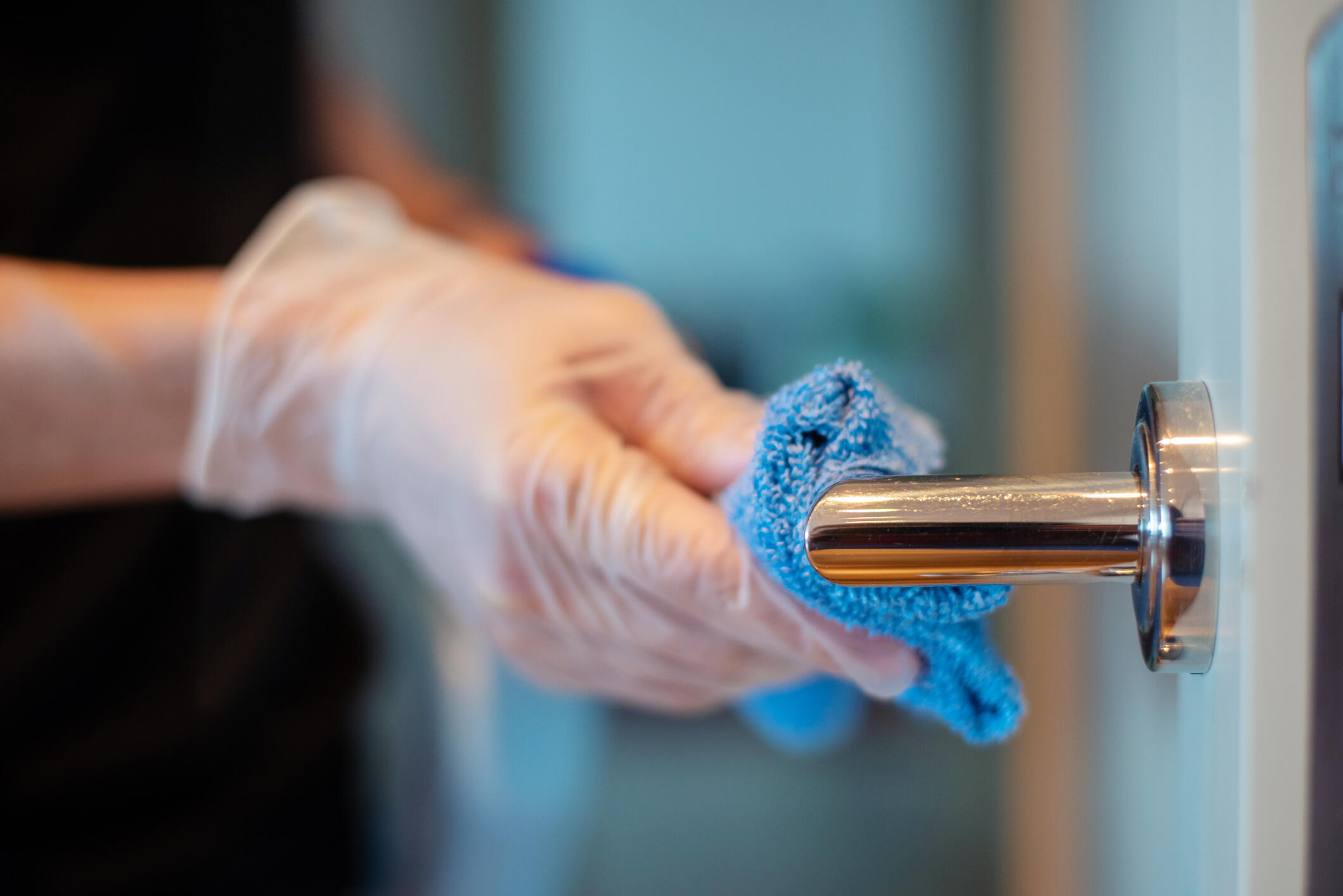 Door handle being cleaned with disinfectant