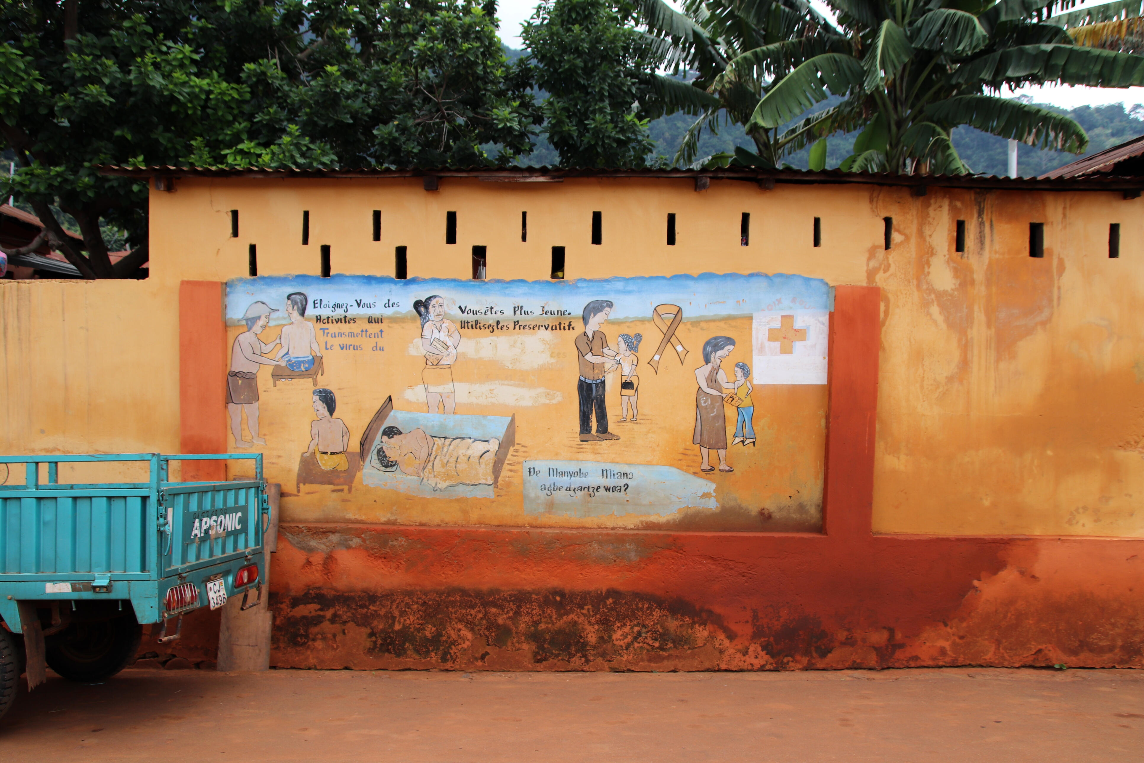 Painted health advice against HIV illness at a wall on a side road between Lomé and Kpalimé near Assahoun in Togo, West Africa.