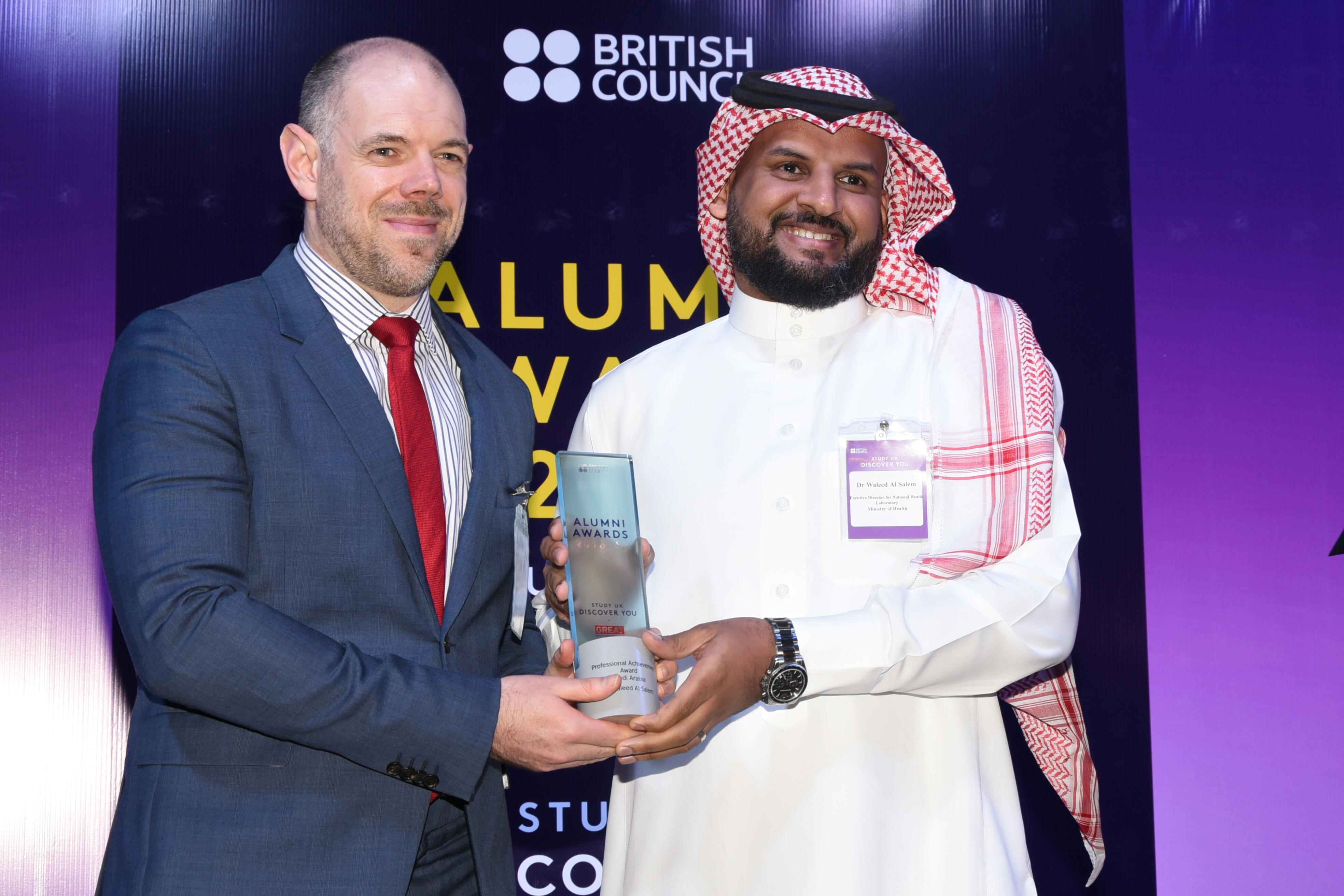 Dr Waleed receiving the award from deputy ambassador Mr Richard Oppenheim