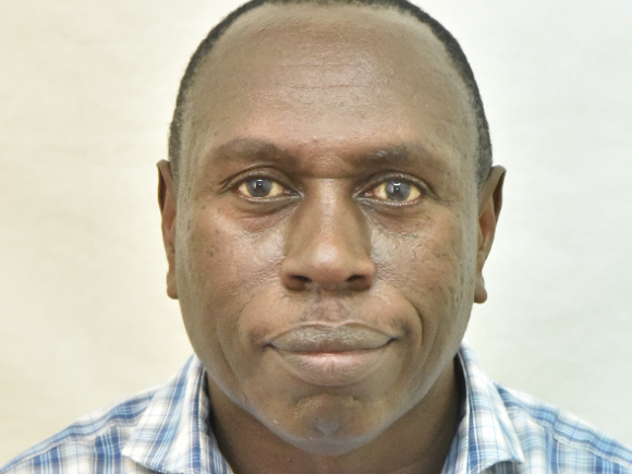 Headshot of Dr Sam Kariuki