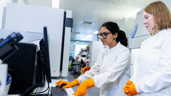 LSTM researchers looking at a computer screen