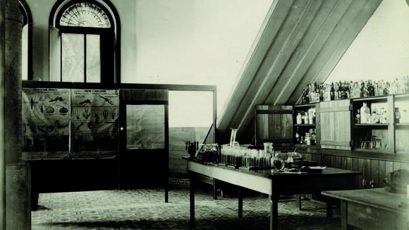 Laboratory interior with posters and a laboratory bench with test tubes