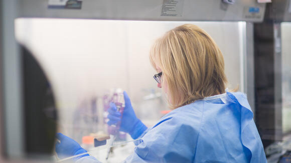 Female scientist working in high-security laboratory