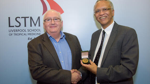 Professor Steve Ward (left) presents the Leverhulme Medal to Professor Jimmy Volmink