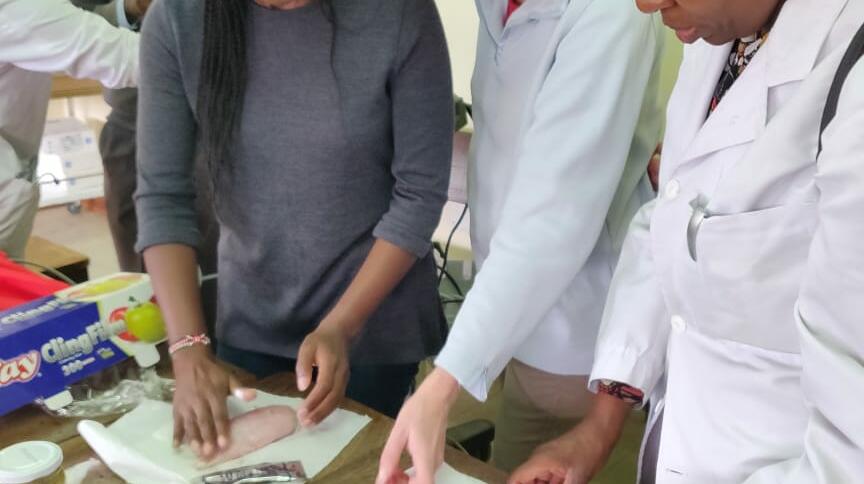 Wanjiku and Ingeborg using available resources to demonstrate the use of Ultrasound in vascular access and biopsy training (chicken breasts with olives hidden inside!)