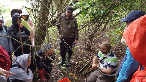 Professor Stothard (seated) teaching fresh water sampling to MSc students 