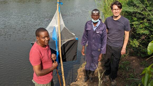 Dr Albert Mugenyi from Co-ordinating Office for Control of Trypanosomiasis in Uganda (COCTU), Benson Orach, Trap Attendant and Dr Andrew Hope from LSTM