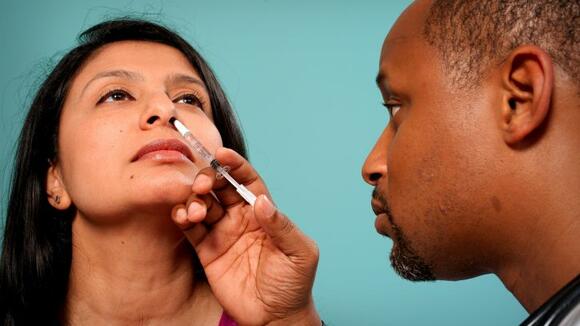 Doctor with nasal spray vaccine 