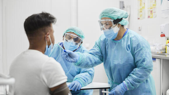 Female Doctor Taking Coronavirus Sample From Man