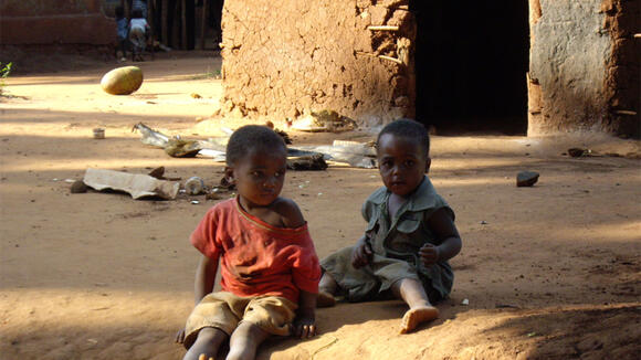 Two children sitting in the dust