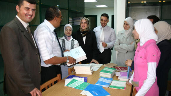 The graduates talking to Dr. Hassan