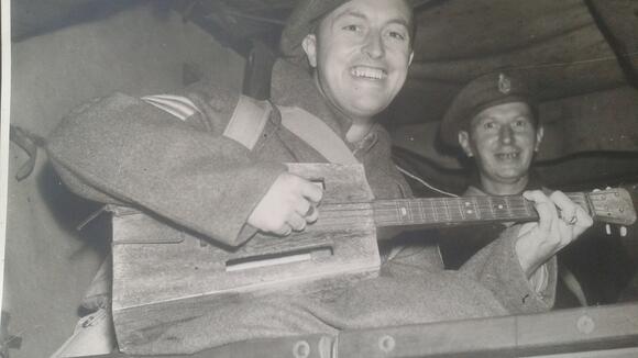 Tom with his ukulele after being repatriated to the UK