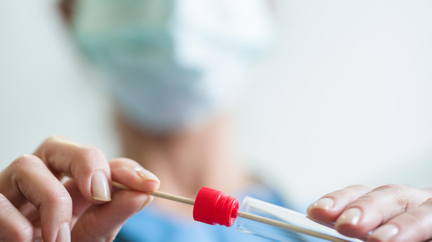 Close up of doctor with saliva sample from sick woman