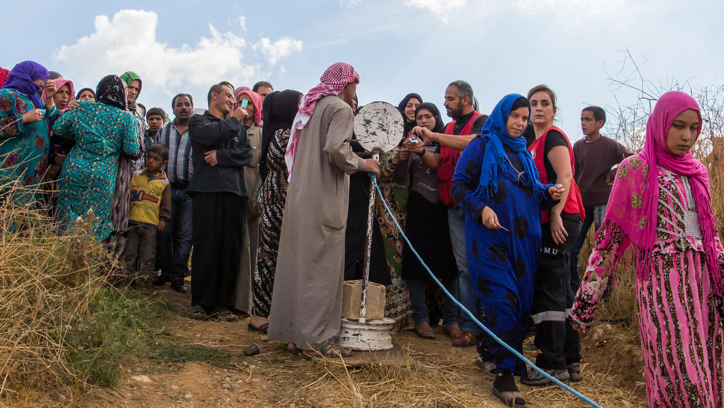 Refugees waiting to receive aid packages from humanitarian aid organisations in the Beqaa region Lebanon.